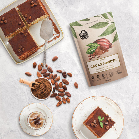 A package of Cacao Powder with four pieces of tiramisu and cacao beans in a bowl