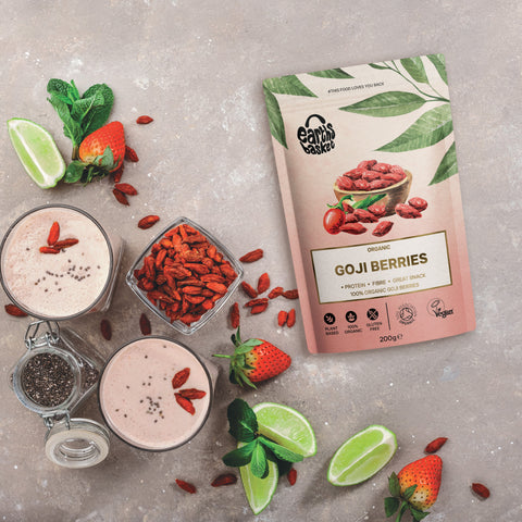 A package of Goji Berries next to goji berry smoothie and lemon wedges