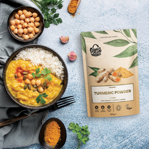 A packaging of Turmeric Powder  with a bowl of yellow dal and rice 