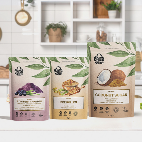  Discover three stunning packaging designs for Breakfast club Bundle standing on a kitchen worktop: Bee Pollen, Acai Berry, and Coconut sugar. Pastel colors, watercolor ingredient images, and product benefits and certifications showcased. 